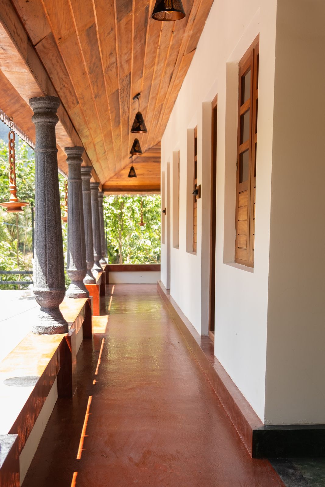 Looking down the long verandah, lamps hanging between the pillars